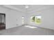 Spacious main bedroom features tray ceiling, fan, carpeted floor, and natural light at 7563 Sw 78Th Ter, Ocala, FL 34481