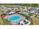 Community pool featuring lounge chairs, tables, shade structure and well-manicured landscaping at 7563 Sw 78Th Ter, Ocala, FL 34481