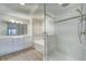 Modern bathroom with glass-enclosed shower, soaking tub, double vanity, and contemporary fixtures at 7651 Whisper Way # 104, Reunion, FL 34747