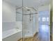 Bathroom boasts a glass-enclosed shower, soaking tub, and contemporary tile work, providing a luxurious experience at 7651 Whisper Way # 104, Reunion, FL 34747