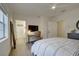 Bedroom featuring a comfortable bed, a work desk, and neutral decor, promoting relaxation and productivity at 7651 Whisper Way # 104, Reunion, FL 34747