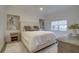 Cozy bedroom featuring a king bed with neutral bedding, stylish artwork, and ample natural light at 7651 Whisper Way # 104, Reunion, FL 34747