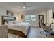 Bedroom featuring a comfortable bed, a window view, and a work area, blending relaxation with productivity at 7651 Whisper Way # 104, Reunion, FL 34747