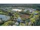 Aerial view of a planned community featuring picturesque homes surrounding a serene lake and wooded area at 7651 Whisper Way # 104, Reunion, FL 34747