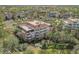 Exterior shot of condominium featuring balconies, palm trees, and neatly landscaped grounds at 7651 Whisper Way # 104, Reunion, FL 34747