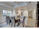 Dining area and modern kitchen with stainless steel appliances, next to a window and table with six chairs at 7651 Whisper Way # 104, Reunion, FL 34747