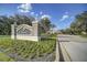 Community sign with flower beds under clear blue skies at 7651 Whisper Way # 104, Reunion, FL 34747