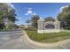 Community sign, floral landscaping, guardhouse visible in the background at 7651 Whisper Way # 104, Reunion, FL 34747