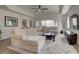 Spacious living room with a large sectional sofa, tray ceiling, and big windows offering ample natural light at 7651 Whisper Way # 104, Reunion, FL 34747