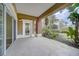 Covered patio with brick column overlooking landscaping, providing a serene outdoor space for relaxation and entertainment at 7651 Whisper Way # 104, Reunion, FL 34747
