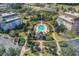 Aerial view of an inviting community pool surrounded by manicured lawns and residential buildings at 7651 Whisper Way # 104, Reunion, FL 34747