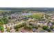 Wide aerial view of a residential community, with green spaces and a peaceful pond in the landscape at 7718 Cafaro Dr, Orlando, FL 32818