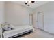 Neutrally decorated bedroom with a ceiling fan, closet, and carpet at 7718 Cafaro Dr, Orlando, FL 32818