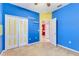 Bright bedroom with blue walls features a walk-in closet and adjoins the bathroom at 7718 Cafaro Dr, Orlando, FL 32818