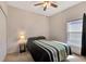 Cozy bedroom with a ceiling fan, neutral walls, and a comfortable queen-size bed at 7718 Cafaro Dr, Orlando, FL 32818