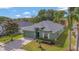 Front exterior featuring well-maintained landscaping, a two-car garage, and a charming architectural style at 7718 Cafaro Dr, Orlando, FL 32818