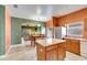 Open-concept kitchen with island flows into the dining area and is accented with stainless steel appliances at 7718 Cafaro Dr, Orlando, FL 32818