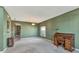 Spacious living room featuring carpet floors, lots of natural light, and a vintage writing desk at 7718 Cafaro Dr, Orlando, FL 32818