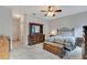 Spacious main bedroom with a ceiling fan, dresser, chest of drawers, and neutral carpeting at 7718 Cafaro Dr, Orlando, FL 32818