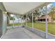 Screened-in patio provides an ideal spot for outdoor dining and relaxation with views of the landscaped backyard at 7718 Cafaro Dr, Orlando, FL 32818