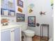 Bathroom area with tile floors, a sink, a toilet, and fish-themed decorations at 7761 Hillcrest Ter, Orlando, FL 32810