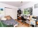 Bedroom area with window, wooden floors, workspace, and closet at 7761 Hillcrest Ter, Orlando, FL 32810