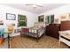 Bright bedroom with wooden floors, large windows, and neutral walls at 7761 Hillcrest Ter, Orlando, FL 32810