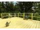 Yellow wooden deck surrounded by lush greenery, perfect for outdoor relaxation and enjoying the natural scenery at 7761 Hillcrest Ter, Orlando, FL 32810