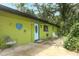 Charming exterior of home featuring a unique painted facade and well-maintained landscaping at 7761 Hillcrest Ter, Orlando, FL 32810