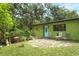 Inviting exterior view with lush landscaping, stone patio, and charming curb appeal at 7761 Hillcrest Ter, Orlando, FL 32810