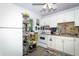 Bright kitchen with white cabinets, light countertops, and modern appliances at 7761 Hillcrest Ter, Orlando, FL 32810