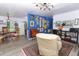 Open-concept living space with dining area, colorful accent wall, and stylish furnishings at 7761 Hillcrest Ter, Orlando, FL 32810