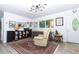 Bright living room featuring a comfortable recliner, unique decor, and ample natural light at 7761 Hillcrest Ter, Orlando, FL 32810