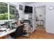 Workspace area with window, wooden floors, and adjacent bathroom at 7761 Hillcrest Ter, Orlando, FL 32810