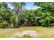 Lush backyard with mature trees provides a serene, private outdoor living space at 7807 Napoleon St, Orlando, FL 32825