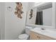 Bathroom with decorative wall art, toilet, sink, and a mirror at 7807 Napoleon St, Orlando, FL 32825