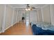 Bedroom featuring white trim, wood flooring, closet, and sliding mirrored closet at 7807 Napoleon St, Orlando, FL 32825