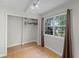 Bedroom with hardwood floors, a closet, and a large window with natural light at 7807 Napoleon St, Orlando, FL 32825