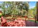 Outdoor deck with a railing overlooking lush greenery and trees at 7807 Napoleon St, Orlando, FL 32825