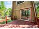 Red deck with sliding glass door provides a space for outdoor relaxation and entertainment at 7807 Napoleon St, Orlando, FL 32825