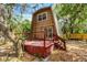 A-frame home with an inviting red deck surrounded by lush greenery at 7807 Napoleon St, Orlando, FL 32825