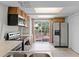 Bright kitchen includes stainless steel appliances, wooden cabinets, and sliding glass doors to the patio at 7807 Napoleon St, Orlando, FL 32825