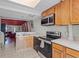 Traditional kitchen features stainless steel appliances, wooden cabinets, and ample counter space at 7807 Napoleon St, Orlando, FL 32825