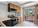 Functional kitchen featuring modern appliances, ample cabinetry, and easy access to outdoor deck at 7807 Napoleon St, Orlando, FL 32825