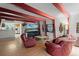 Inviting living room featuring hardwood floors, exposed beams, and cozy red seating at 7807 Napoleon St, Orlando, FL 32825