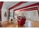 Open concept living room with exposed beams, hardwood floors and a stylish, modern décor at 7807 Napoleon St, Orlando, FL 32825