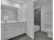 Well-lit bathroom features a double vanity, modern fixtures, and a tiled shower and tub combo at 9153 Harris Hawk Dr, Leesburg, FL 34788