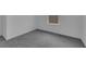 Bright bedroom features soft grey carpeting, neutral walls, and natural light from the window at 9153 Harris Hawk Dr, Leesburg, FL 34788