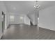 Open living room with luxury vinyl plank flooring and modern lighting fixtures at 9153 Harris Hawk Dr, Leesburg, FL 34788