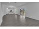 Bright living area with wood flooring, white walls, and sliding glass doors at 9153 Harris Hawk Dr, Leesburg, FL 34788